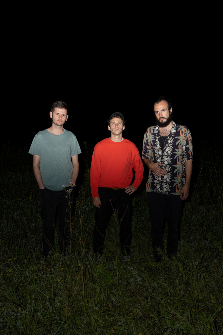 The Band Dubmnent standing in a field at night