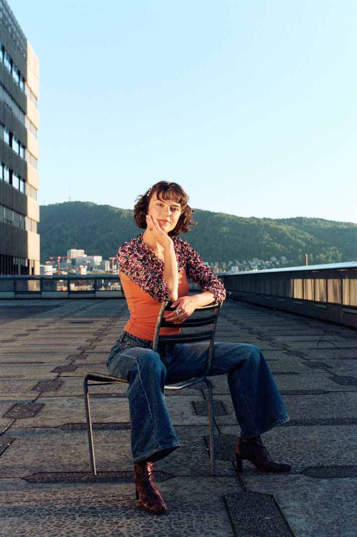 DJ Jil Corti sitting on a chair on the rooftop of ZHDK