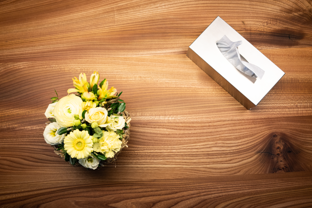 Flowers and tissues on the consultation table of a funeral director.